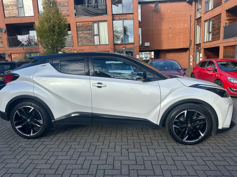 Full side view of the white Toyota C-HR GR Sport teaching car.